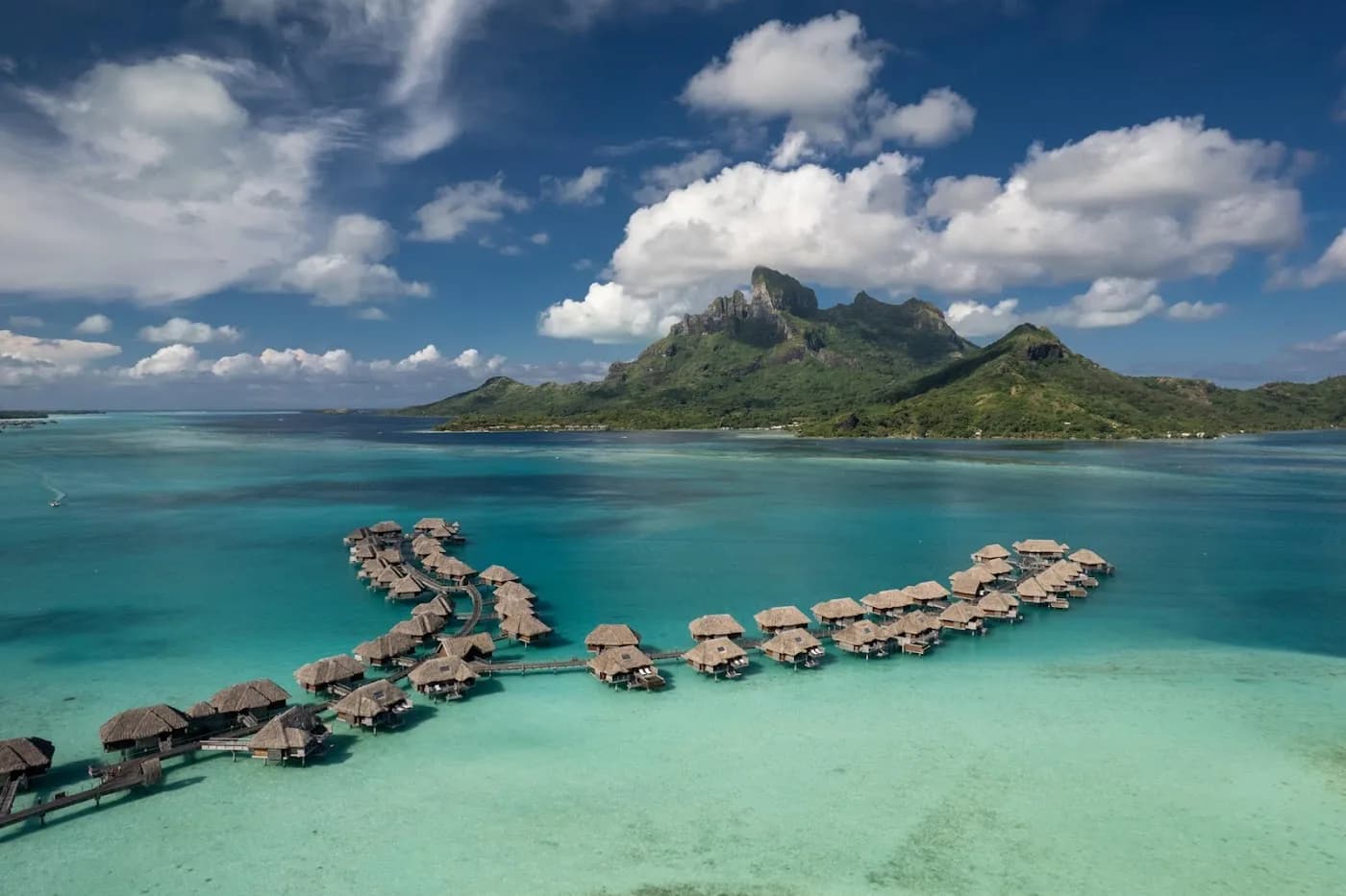 Overwater villa at Four Seasons Bora Bora — the canonical honeymoon image